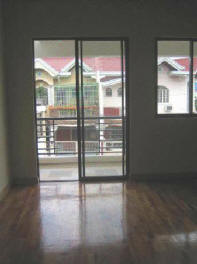 Master bedroom with view of the balcony