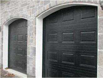 Automatic double garage doors with arched headers.